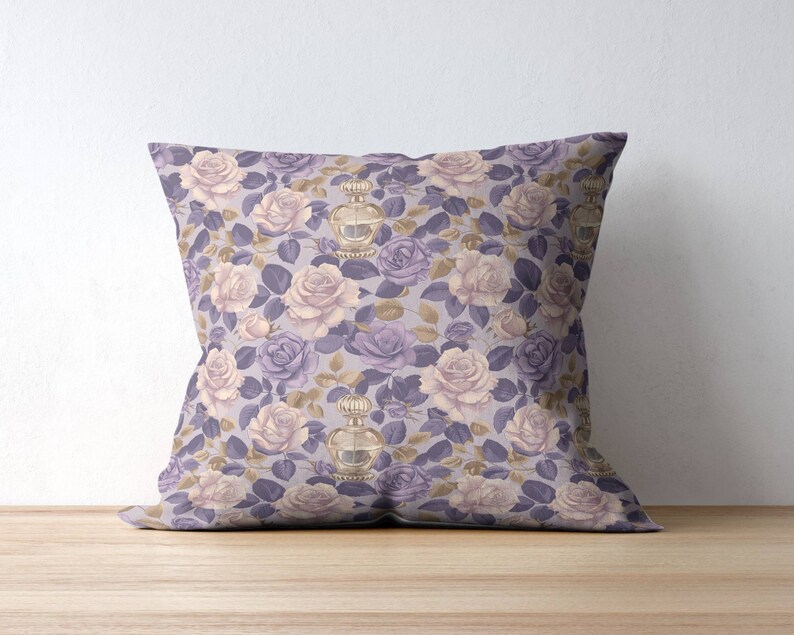 May include: A purple and cream throw pillow with a floral pattern featuring roses and perfume bottles.