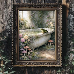 May include: A framed artwork depicts a vintage bathtub scene. The tub is overflowing with water and surrounded by flowers and mushrooms. A green frog sits on the edge. The frame is ornate and dark brown, set against a wooden background.