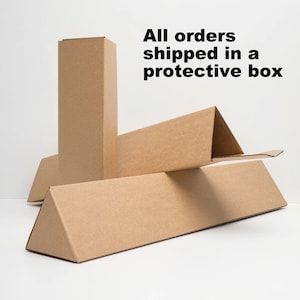 May include: Cardboard shipping boxes in various shapes and sizes. The boxes are made of brown corrugated cardboard and are designed to protect items during shipping. Text on the image reads "All orders shipped in a protective box."