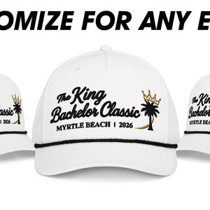 May include: Three white baseball caps with black rope trim across the brim. Each cap features black embroidered text reading The King Bachelor Classic and MYRTLE BEACH | 2026, with a black palm tree and a gold crown icon. Text above reads CUSTOMIZE FOR ANY EVENT!