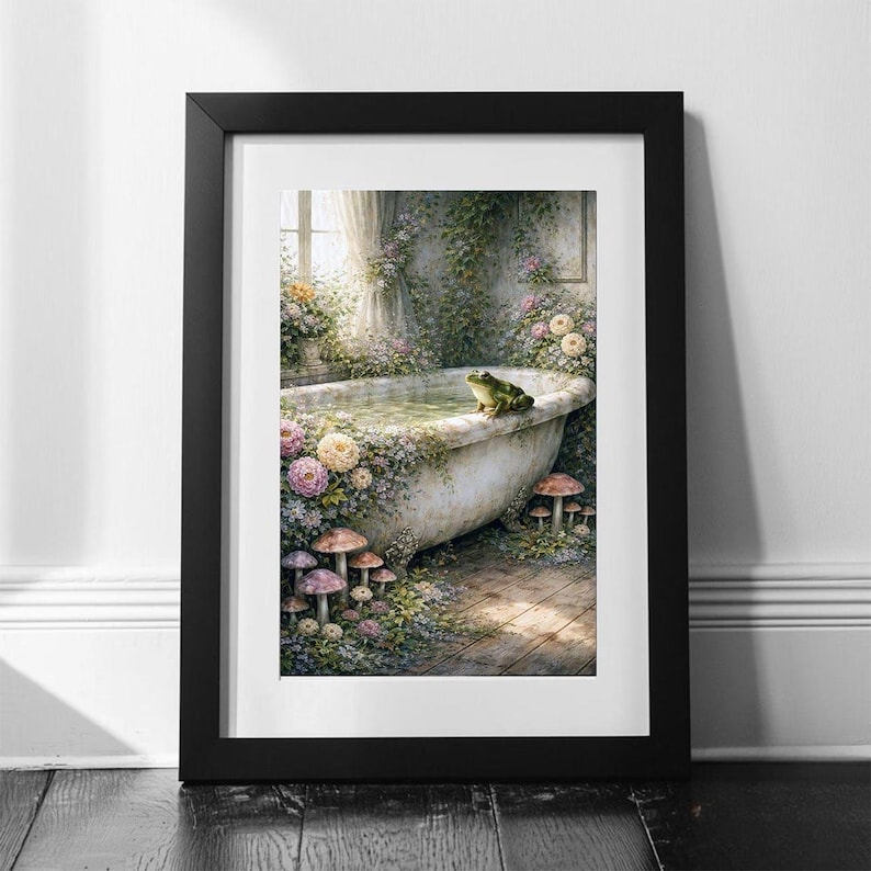 May include: Framed art print featuring a whimsical scene of a vintage bathtub filled with water, surrounded by flowers and mushrooms. A green frog sits on the edge of the tub. The artwork is framed in a black frame.