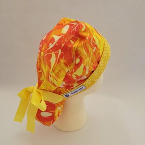 Ponytail Surgical Hat by BrightCaps, Bright Yellow, Orange Swirl with Yellow Diamond Contrast Lining