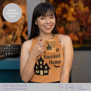 May include: An orange tank top with a black haunted house graphic and the words "Home Sweet Haunted Home" printed on it. A matching mug is held up. The image also includes the text "Digital Download Only!!!".