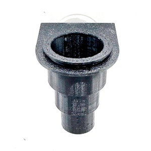 May include: Black plastic drain pipe with a flared top and a round opening. The pipe is designed to connect to a larger drain pipe.