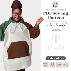 Puede incluir: Una sudadera con capucha blanca, marrón y verde con un gran bolsillo en la parte delantera. La sudadera está diseñada para ser usada como una sudadera con capucha de manta. El texto "harlen blanket hoodie" es visible en la imagen. El texto "Kids + Adults" también es visible en la imagen.