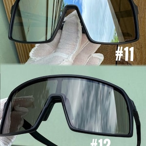 May include: Two pairs of black sport sunglasses. The lenses are tinted and reflect the sky. The frames are thick and wrap around the face. The number "#11" is printed in white on the bottom right of the top pair. The number "#12" is printed in white on the bottom right of the bottom pair.