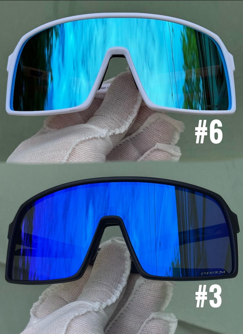 May include: Two pairs of sports sunglasses. One pair has a white frame with blue mirrored lenses, and the other has a black frame with blue mirrored lenses. The number "#6" is printed on the white frame, and "#3" is printed on the black frame.