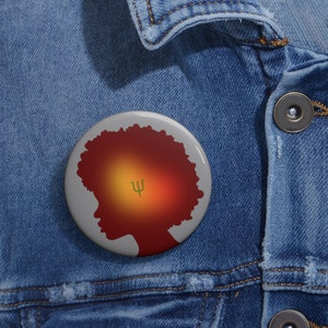 May include: A round button with a silhouette of a person with an afro hairstyle. The silhouette is filled with a gradient of red, orange, and yellow. The Greek letter psi is in the center of the gradient.