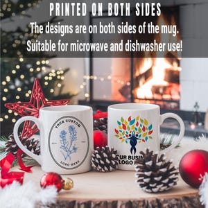 May include: Two white ceramic mugs with different designs. The mug on the left has a blue floral design with the text "YOUR CUSTOM LOGO HERE". The mug on the right has a colorful tree design with the text "OUR BUSINESS LOGO HERE".