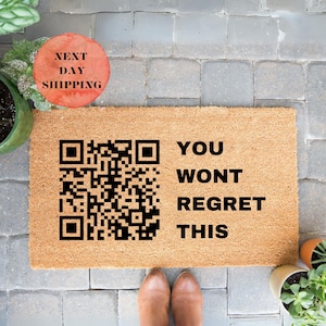 May include: A brown coir doormat with the text "YOU WONT REGRET THIS" and a black and white QR code.