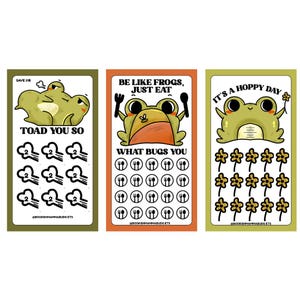 May include: Three colorful cards with frog illustrations. The first card says "TOAD YOU SO" with a grumpy frog. The second card says "BE LIKE FROGS, JUST EAT" with a frog holding utensils. The third card says "IT'S A HOPPY DAY" with a frog holding a flower.