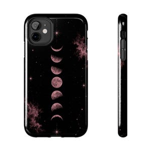 May include: A black phone case featuring a vertical sequence of moon phases in shades of dusty pink. The design includes scattered stars, faint constellations, and soft pink nebula clouds against a dark background, shown from front and side views.