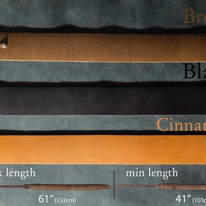May include: Three leather guitar straps in brown, black, and cinnamon colors. The straps are shown laid out horizontally on a textured surface. The straps are adjustable and have a maximum length of 61 inches (153 cm) and a minimum length of 41 inches (103 cm).