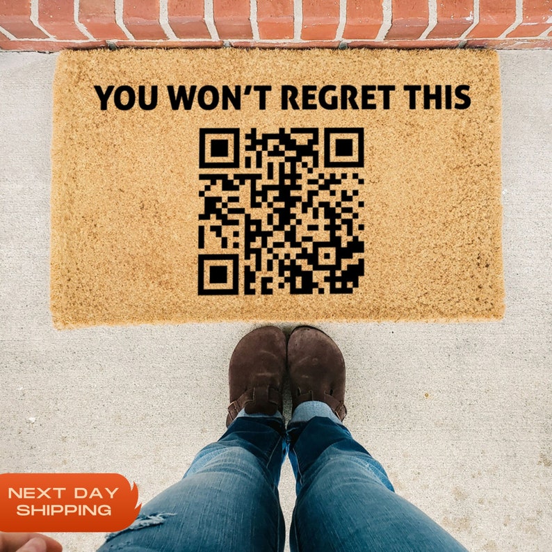 May include: A brown doormat with the text "YOU WON'T REGRET THIS" and a black and white QR code printed on it.