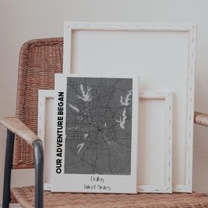 May include: A black and white map of Dallas, Texas, printed on a white canvas with the text "Our Adventure Began" on the left side and "Dallas, United States" at the bottom.