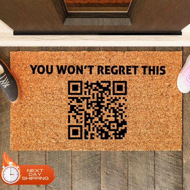 May include: A brown coir doormat with the text "YOU WON'T REGRET THIS" and a black and white QR code.