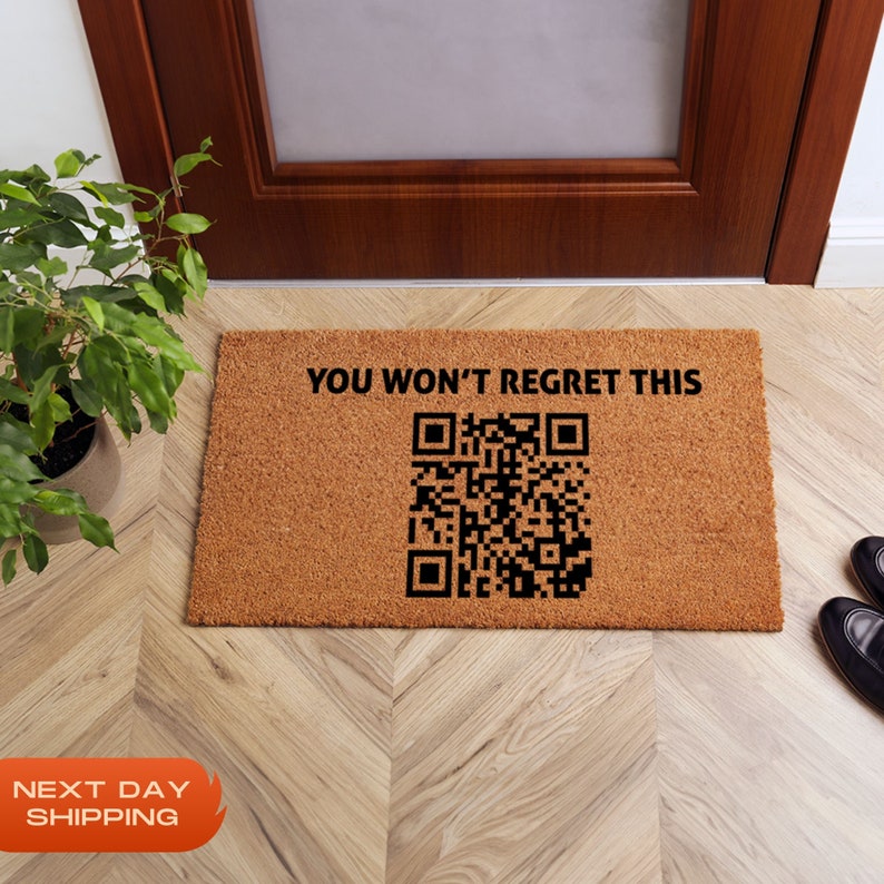 May include: A brown coir doormat with the text "YOU WON'T REGRET THIS" and a black and white QR code.