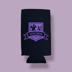 May include: Black neoprene can cooler with a purple design. The design features a shield with a dragon and a griffin, a banner that reads "QUEST SQUAD", and paw prints.