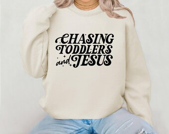 Chasing toddlers and Jesus Crewneck