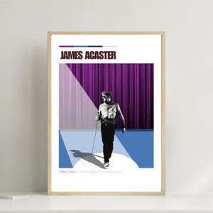 May include: A framed poster featuring a black and white illustration of a person holding a microphone, walking on a stage. The poster has the name "JAMES ACASTER" at the top and a quote at the bottom. The background includes a purple curtain and a blue stage.