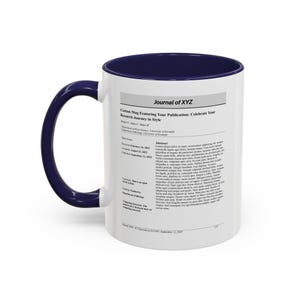 May include: White ceramic mug with a navy blue interior and handle. The mug features text that reads "Journal of XYZ" and "Custom Mug Featuring Your Publication: Celebrate Your Research Journey in Style."