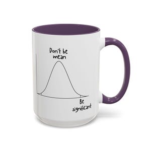 May include: A white ceramic mug with a purple interior and handle. The exterior features a black line drawing of a bell curve graph with the text "Don't be mean" above the peak and "Be significant" below the curve on the right side.