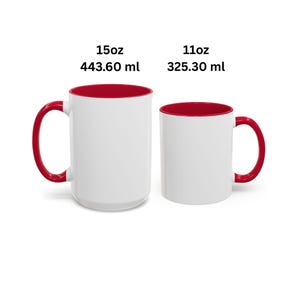 May include: Two white ceramic mugs with red interiors and red handles. The larger mug is labeled 15oz and 443.60 ml, while the smaller mug is labeled 11oz and 325.30 ml. Both mugs feature a plain white exterior surface and a cylindrical shape.