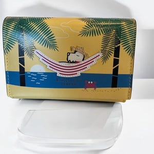 Cartera de piel tipo hamaca amarilla de Radley London.