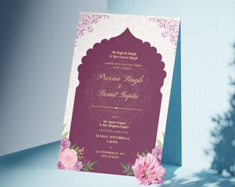 May include: A rectangular wedding invitation card featuring a deep plum central arch with gold text and a mandala design. The border displays light cream patterns and floral illustrations in pink and purple at the bottom corners.
