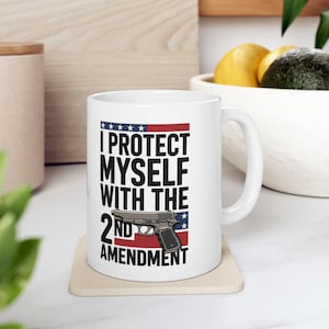 May include: A set of three ceramic mugs with a speckled, matte finish. The mugs are in cream, light grey, and dark grey. Each mug has a simple, minimalist design, ideal for coffee or tea.