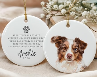 May include: Two white ceramic round ornaments with gold string hangers. One has a paw print and text: "When tomorrow starts without me... I'm right inside your heart." The other features a watercolor dog portrait with brown and blue eyes.
