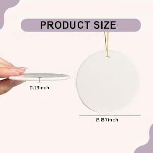 May include: A white, circular ceramic ornament with a gold hanging string. The ornament measures 7.3 cm in diameter and is 0.33 cm thick. The text "PRODUCT SIZE" is displayed above the ornament.