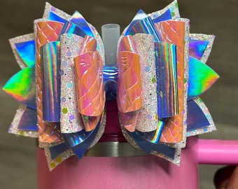 Textured pink, sparkly light pink, and holographic blue tumbler bow