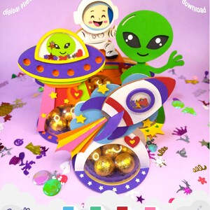 May include: A colorful papercraft space-themed design featuring an astronaut, an alien, a UFO, and a rocket ship. The design includes the text "FOR CRICUT SILHOUETTE" and "instant download". The design also includes the text "digital files digital" and "Cosmic 33".