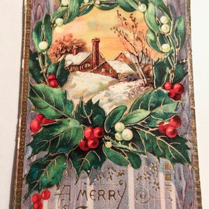 Auténtica postal navideña vintage de 1910: pieza única de colección navideña con escritura y daños por el paso del tiempo.