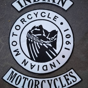 May include: Three white and black embroidered patches for a motorcycle jacket. The largest patch is a circle with the words "Indian Motorcycle" and the year "1901" around a black and white image of an Indian head. The other two patches are curved and say "Indian" and "Motorcycles" in white letters on a black background.