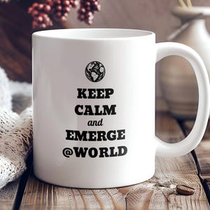 May include: White ceramic coffee mug with black text that reads "Keep Calm and Emerge @World". The mug has a black and white image of the Earth on it.