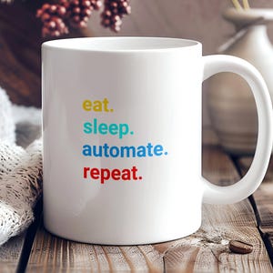 May include: White ceramic mug with a colorful text design that reads "eat. sleep. automate. repeat."