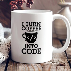 May include: White ceramic coffee mug with black text that reads "I turn coffee into code". The mug has a black illustration of a coffee cup with code symbols inside.