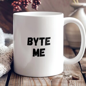 May include: White ceramic mug with black text that reads "BYTE ME".