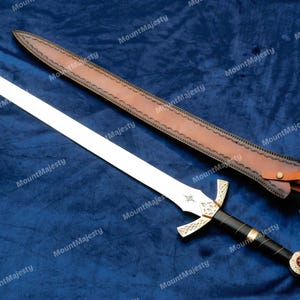 May include: A silver sword with a black handle and a gold pommel. The sword has a leather scabbard with a decorative design.