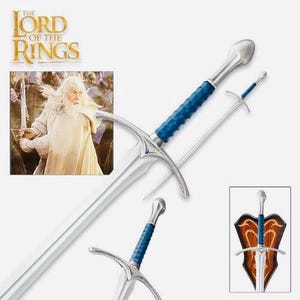 May include: A silver sword with a blue handle and a silver blade. The sword is displayed on a wooden stand with a shield featuring a dragon design. The text "The Lord of the Rings" is visible in the background.