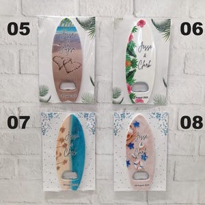 May include: Surfboard-shaped bottle openers with various designs, including beach scenes, floral patterns, and personalized text. Each opener has a silver bottle opener and is packaged on a white card. The text on the openers reads "Jesse & Clark" and a date.