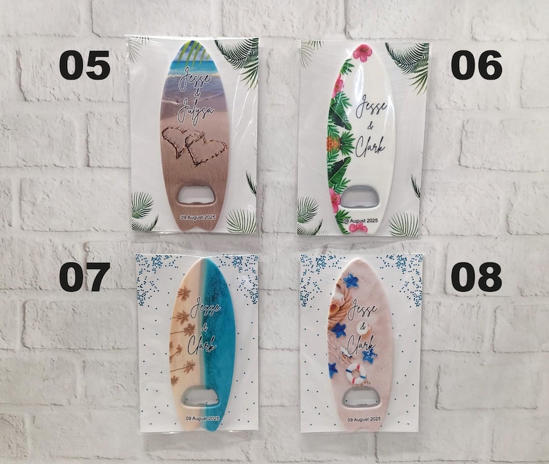 May include: Surfboard-shaped bottle openers with various designs, including beach scenes, floral patterns, and personalized text. Each opener has a silver bottle opener and is packaged on a white card. The text on the openers reads "Jesse & Clark" and a date.