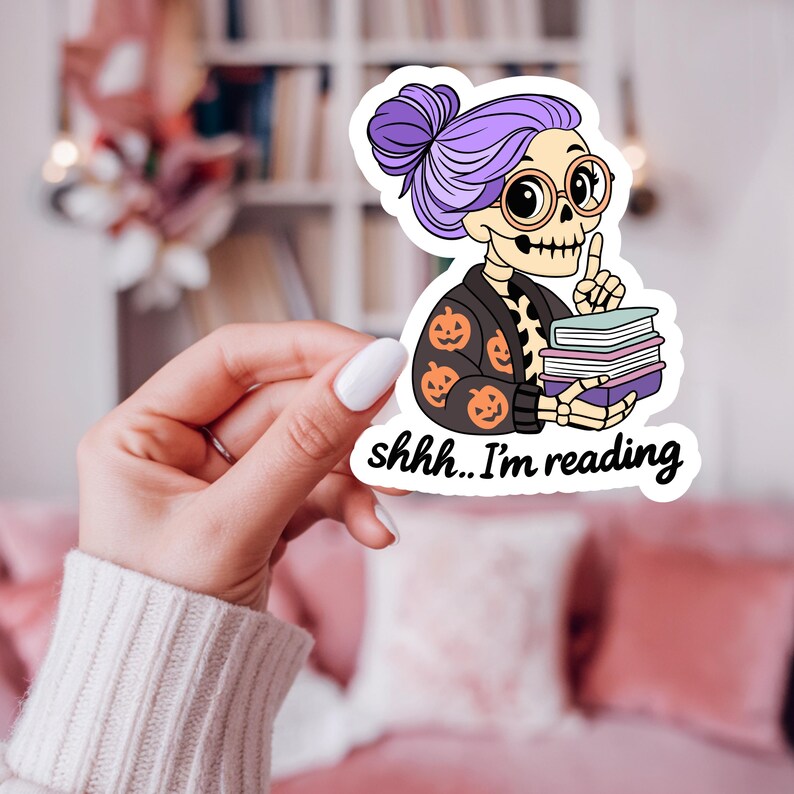 Shh I'm reading sticker design png file of a spooky librarian skeleton