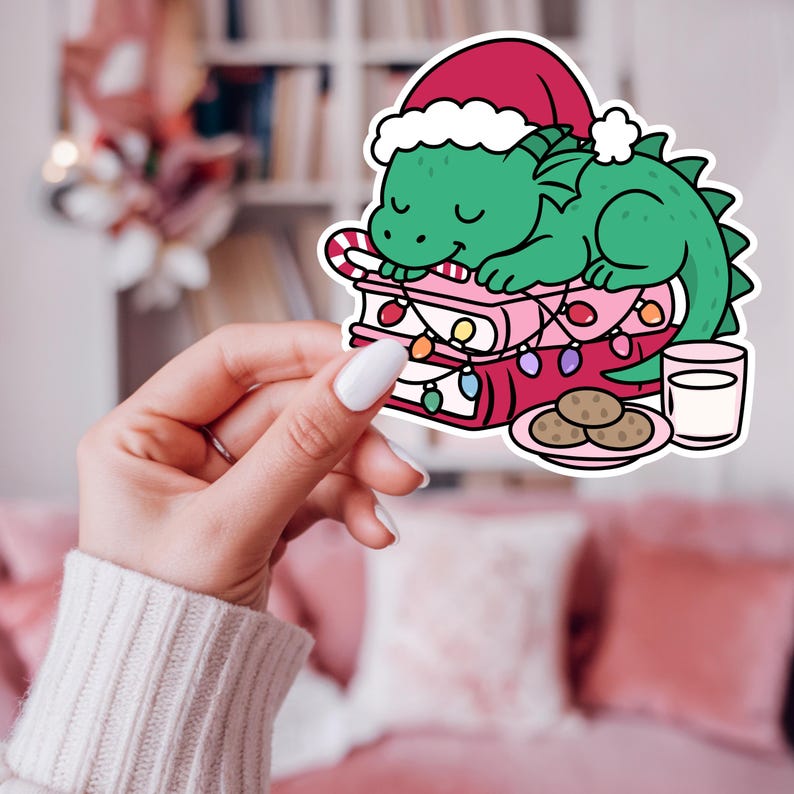 Christmas book dragon png design shown as a kindle sticker.