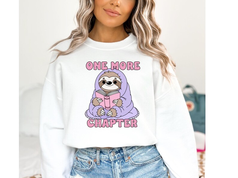 A bookish sweatshirt png mockup of the One More Chapter design.