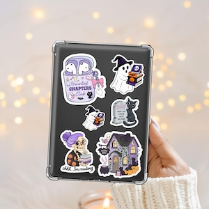 Spooky Halloween bookish themed kindle sticker png designs including ghosts, black cats, a haunted bookshop and skeleton librarian.