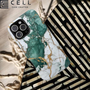 May include: A white and green marble-patterned phone case with gold veining. The case has a glossy finish and a camera cutout. The brand name "CELL CASE CRAFTER" is printed in black at the top left corner.