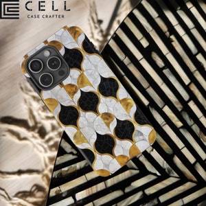 May include: A black phone case with a geometric pattern of white and gold circles. The case has a raised camera bump and the text "CELL CASE CRAFTERS" is printed on the top.